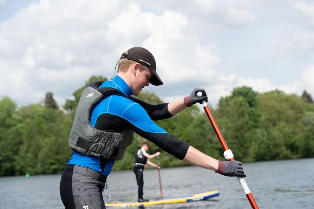 Young man paddle boarding